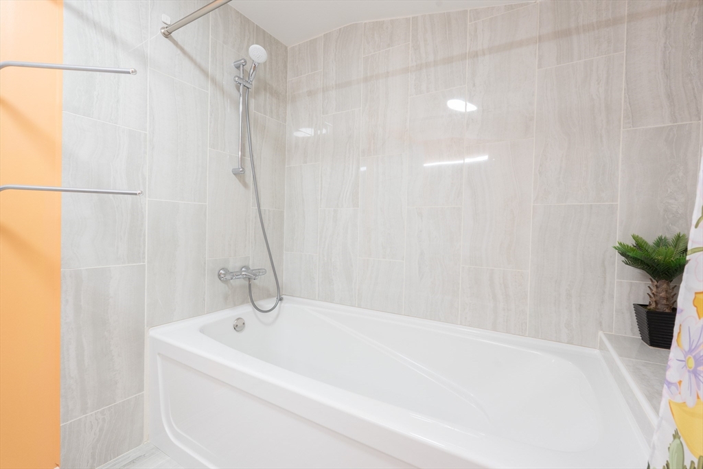 5 Fairview Road Canton, MA 02021 - Photo 18 of 28 a white bath tub sitting next to a shower