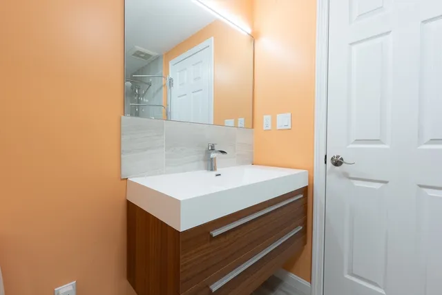 a bathroom with a sink a toilet and a window