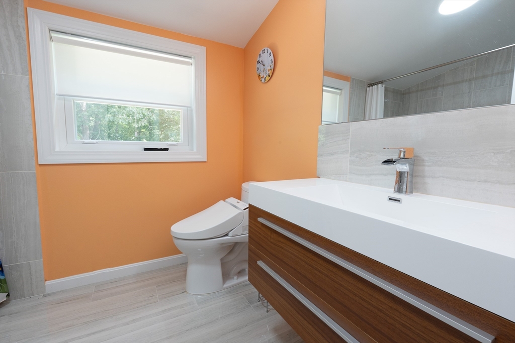 5 Fairview Road Canton, MA 02021 - Photo 20 of 28 a bathroom with a sink a toilet and a window