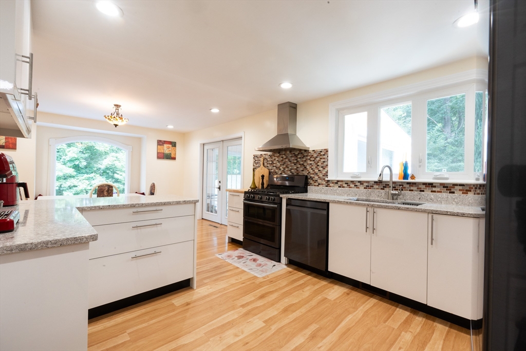 5 Fairview Road Canton, MA 02021 - Photo 9 of 28 a kitchen with stainless steel appliances kitchen island granite countertop a stove a sink and a refrigerator
