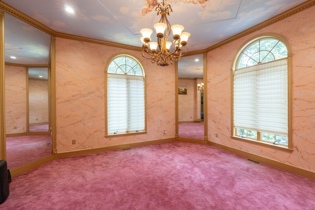 5 Fairview Road Canton, MA 02021 - Photo 10 of 28 an empty room with windows chandeliers and kitchen view