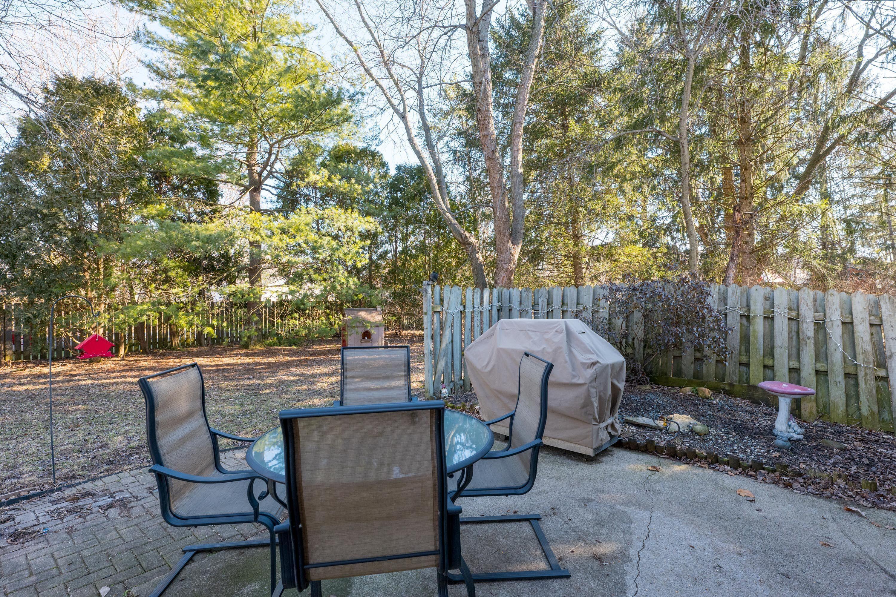 7826 Strathmoore Road Dublin, OH 43016 - Photo 20 of 47 Quite Back Patio with Trees in the Background.
