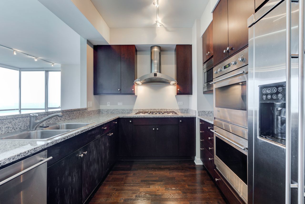 1201 South Prairie Avenue, Unit 1803 Chicago, IL 60605 - Photo 4 of 27 a kitchen with stainless steel appliances granite countertop a sink and a stove