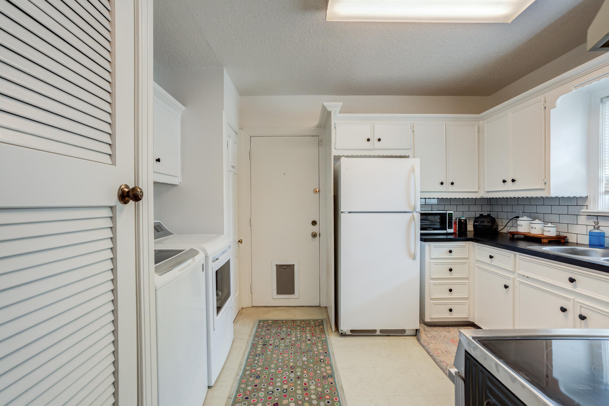 2826 33rd Street Lubbock, TX 79410 - Photo 19 of 33 a kitchen with white cabinets and white appliances
