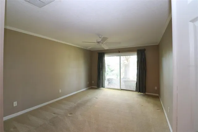 a view of kitchen with windows and refrigerator