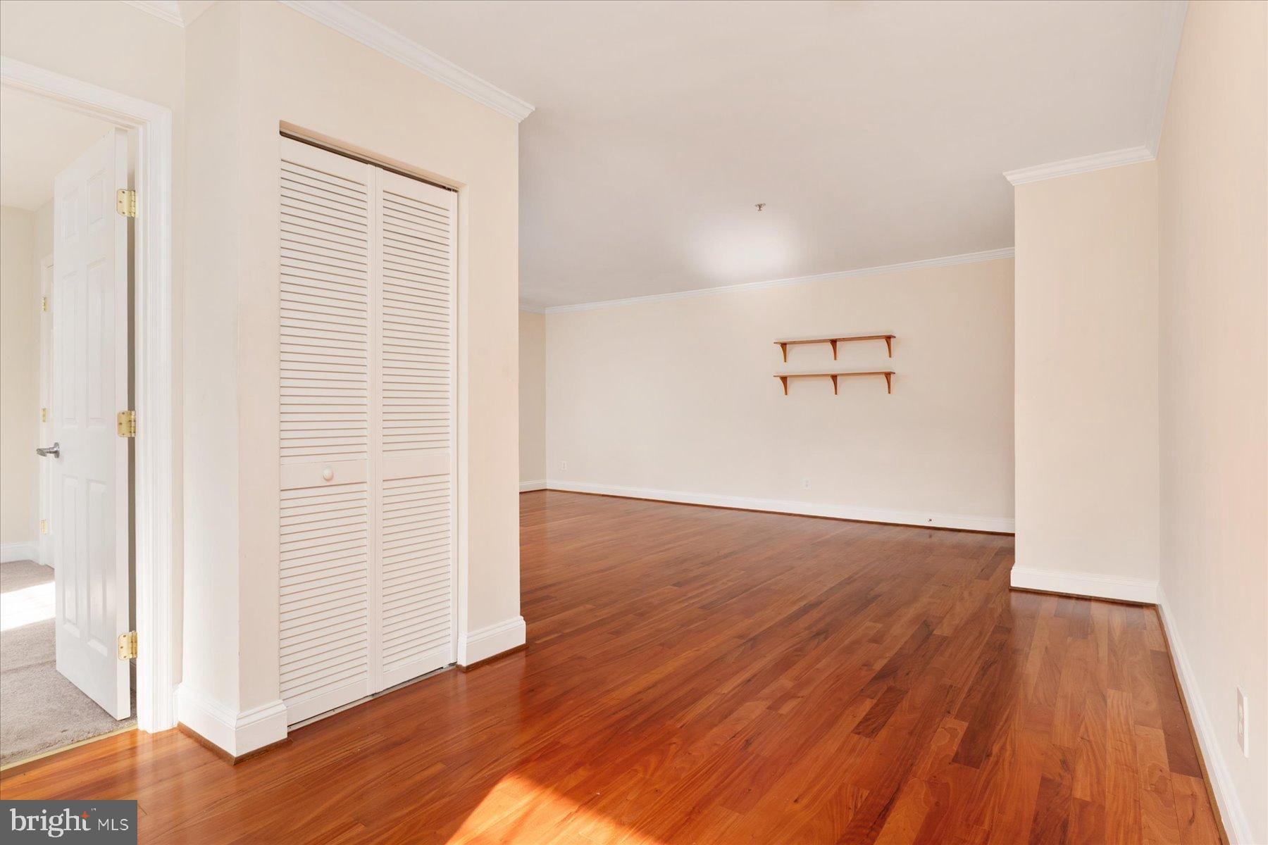 19 Post, Unit AVENUE 203 Laurel, MD 20707 - Photo 16 of 32 an empty room with wooden floor and windows