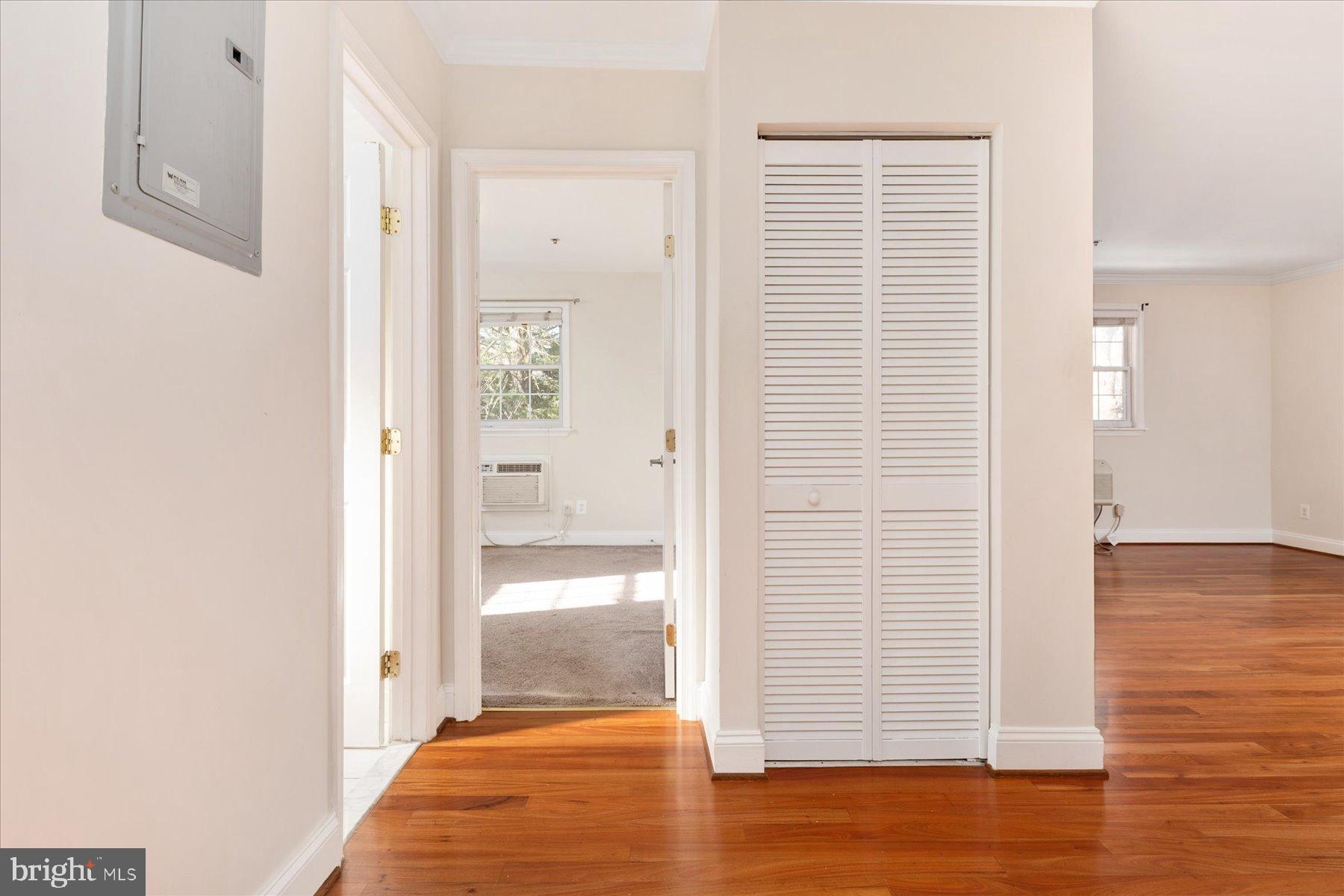 19 Post, Unit AVENUE 203 Laurel, MD 20707 - Photo 17 of 32 a view of a hallway with wooden floor and a bathroom