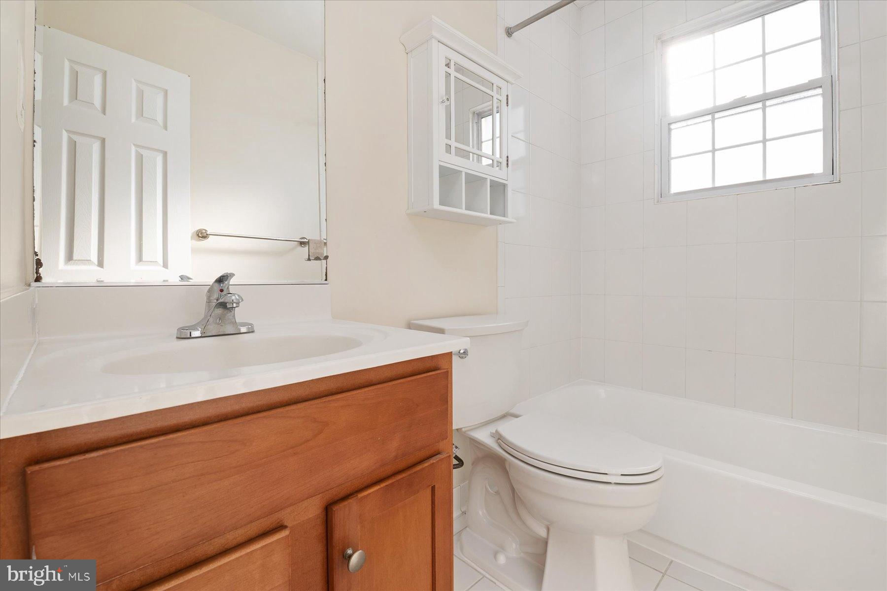 19 Post, Unit AVENUE 203 Laurel, MD 20707 - Photo 22 of 32 a bathroom with a sink a toilet and a tub