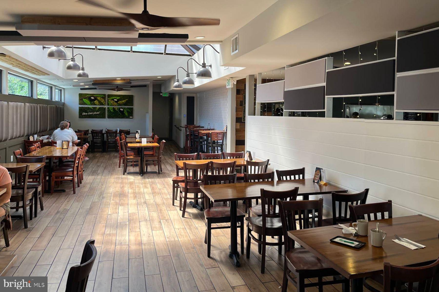 19 Post, Unit AVENUE 203 Laurel, MD 20707 - Photo 27 of 32 a view of a dining area with furniture and wooden floor