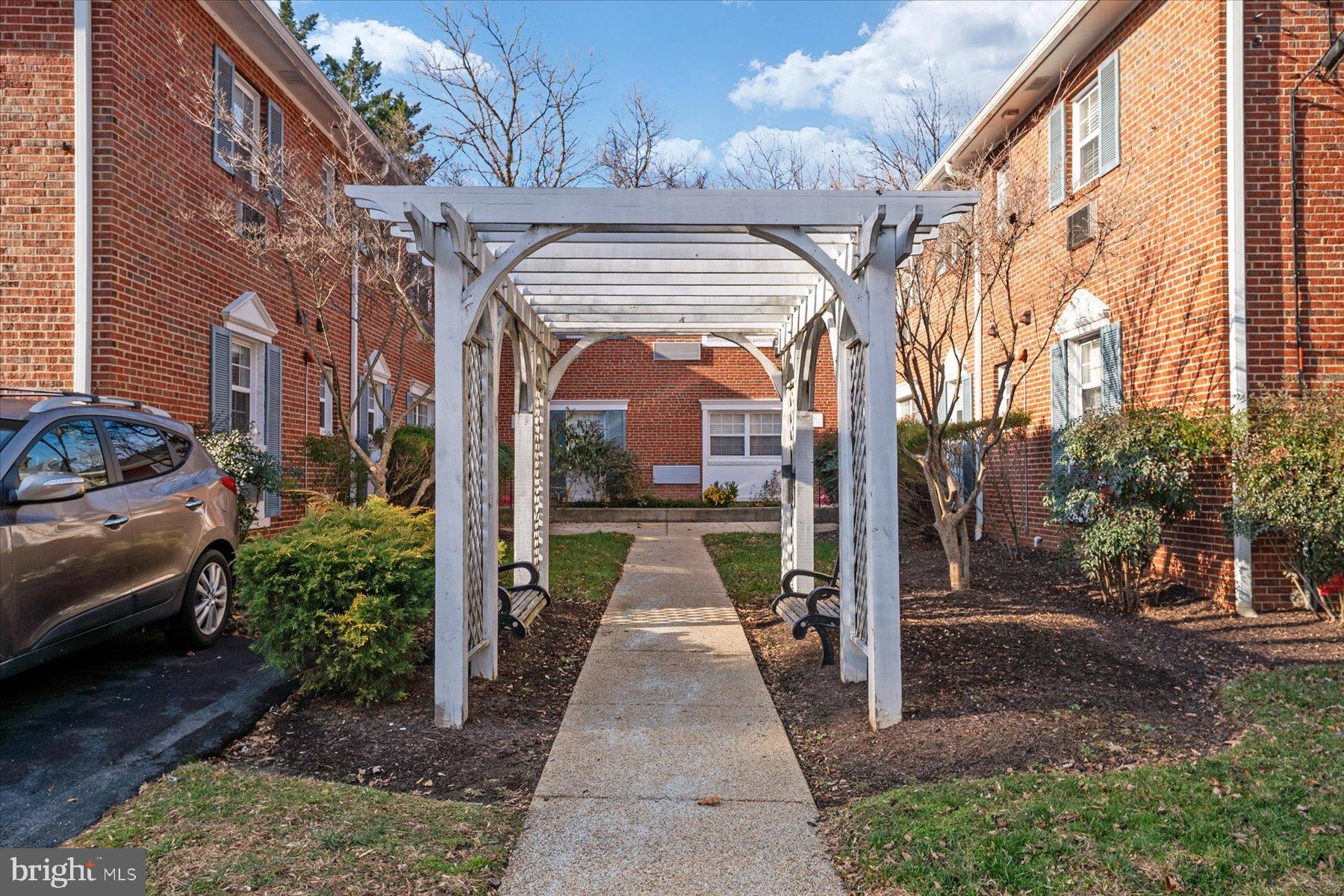 19 Post, Unit AVENUE 203 Laurel, MD 20707 - Photo 4 of 32 a view of a brick house with a street
