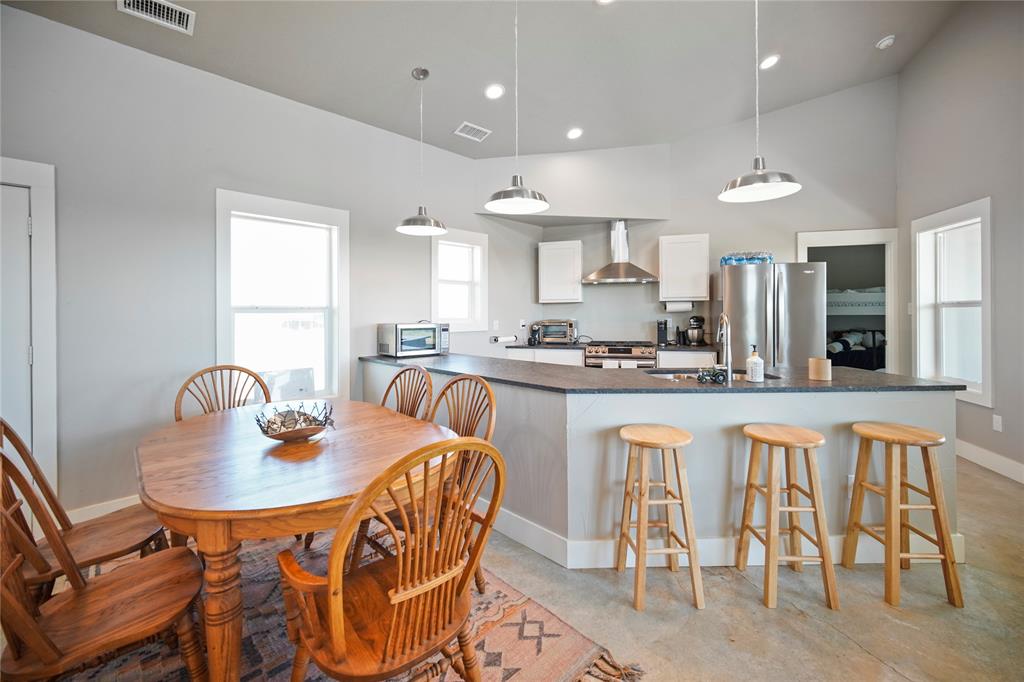 131.7-acres Roney Road Jacksboro, TX 76458 - Photo 11 of 40 a kitchen with stainless steel appliances granite countertop a table and chairs