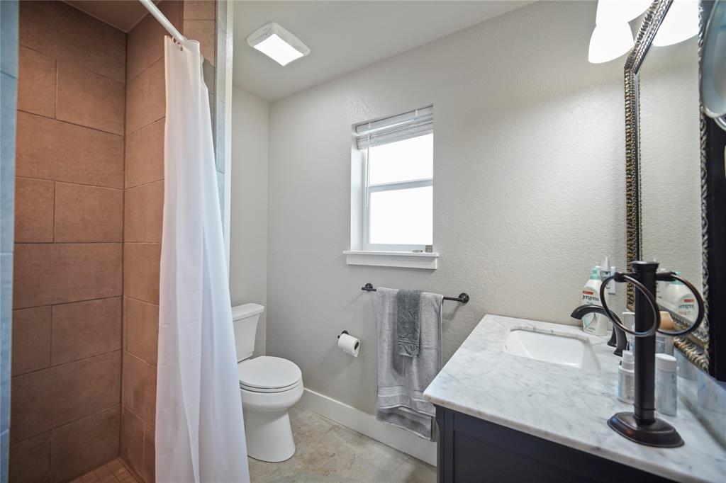 131.7-acres Roney Road Jacksboro, TX 76458 - Photo 14 of 40 a bathroom with a granite countertop sink toilet and shower