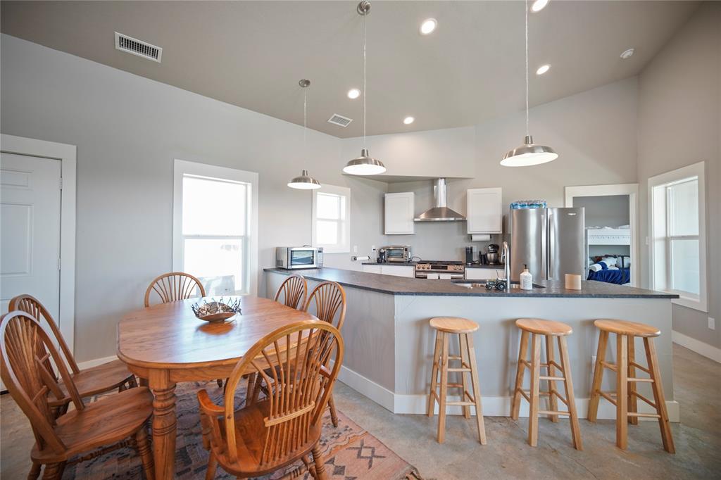 131.7-acres Roney Road Jacksboro, TX 76458 - Photo 6 of 40 a dining room with stainless steel appliances granite countertop a dining table and chairs
