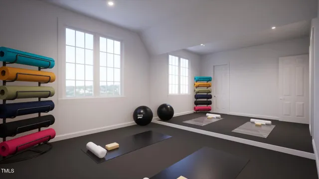 a bedroom with furniture and a large window