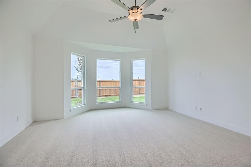 2620 Cedar Rdg Road Celina, TX 75009 - Photo 12 of 27 Carpeted spare room featuring a ceiling fan and a high ceiling