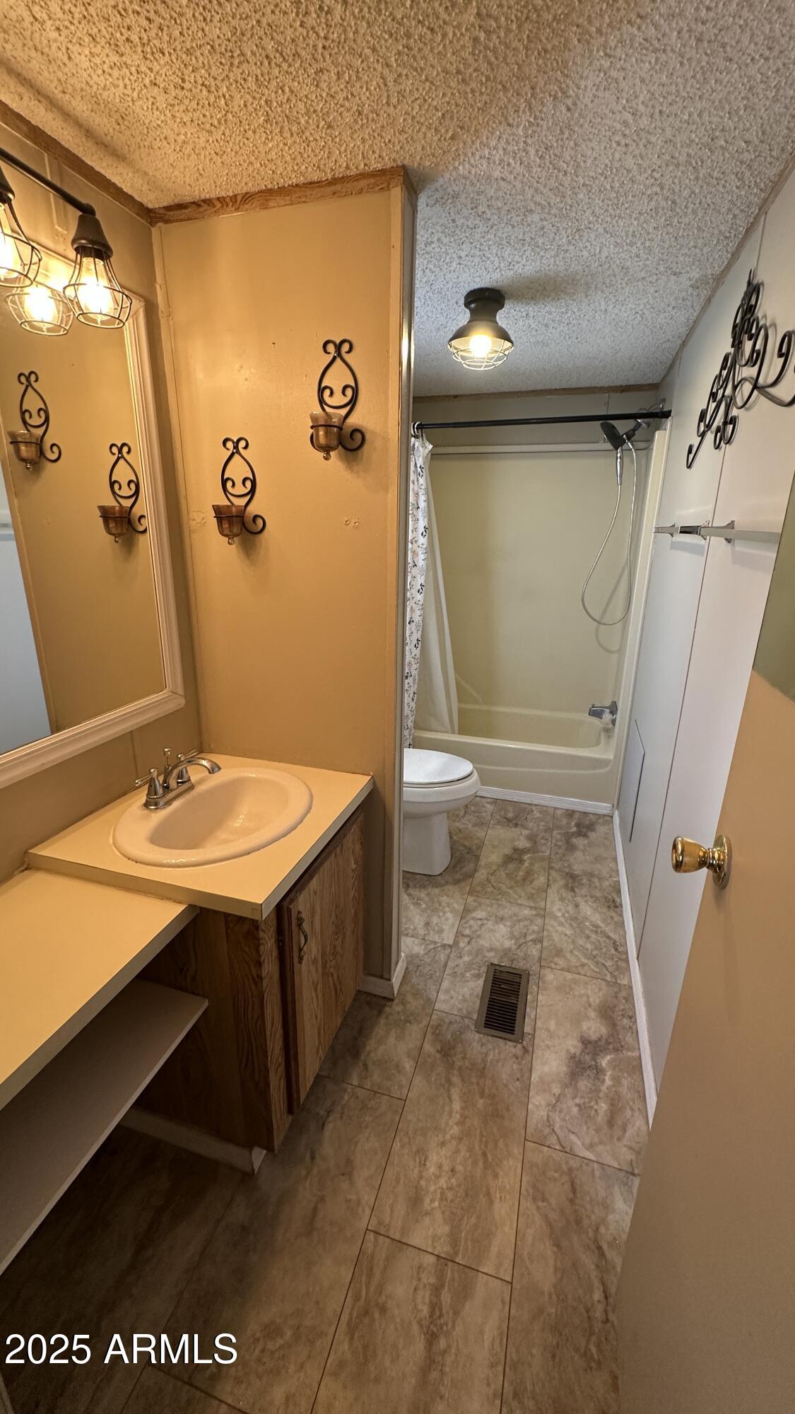 834 South Meridian Road, Unit 105 Apache Junction, AZ 85120 - Photo 16 of 48 a bathroom with a sink a toilet and shower