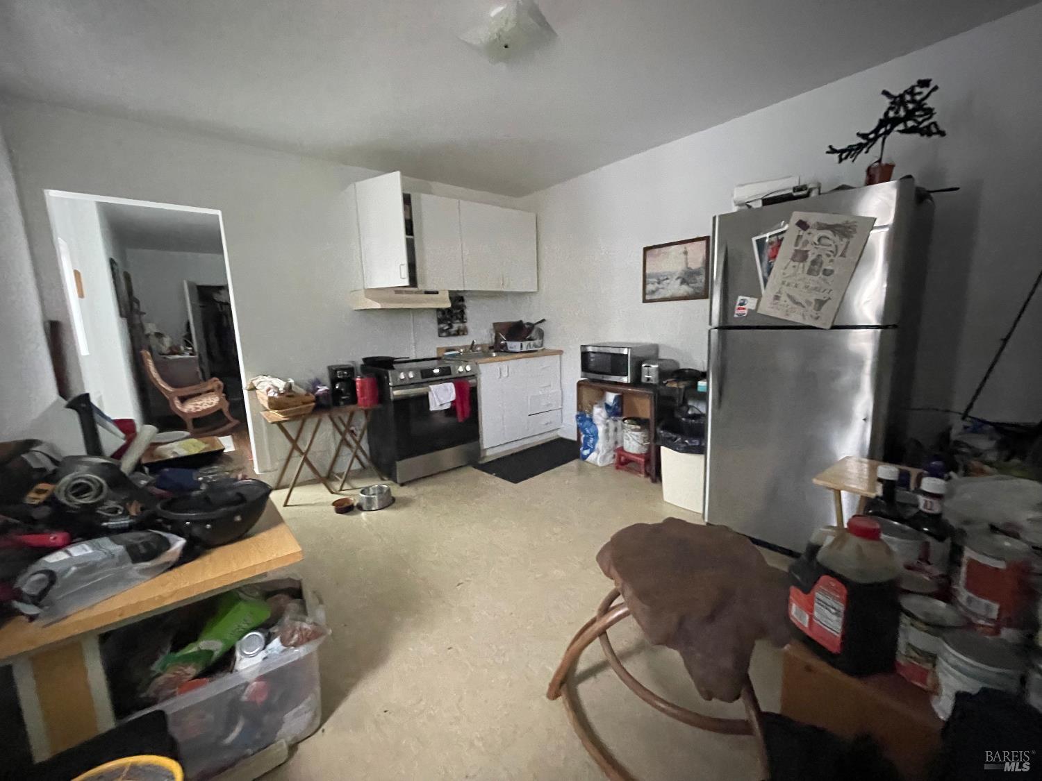 321 North Franklin Street Fort Bragg, CA 95437 - Photo 17 of 23 a living room with furniture a flat screen tv and a refrigerator