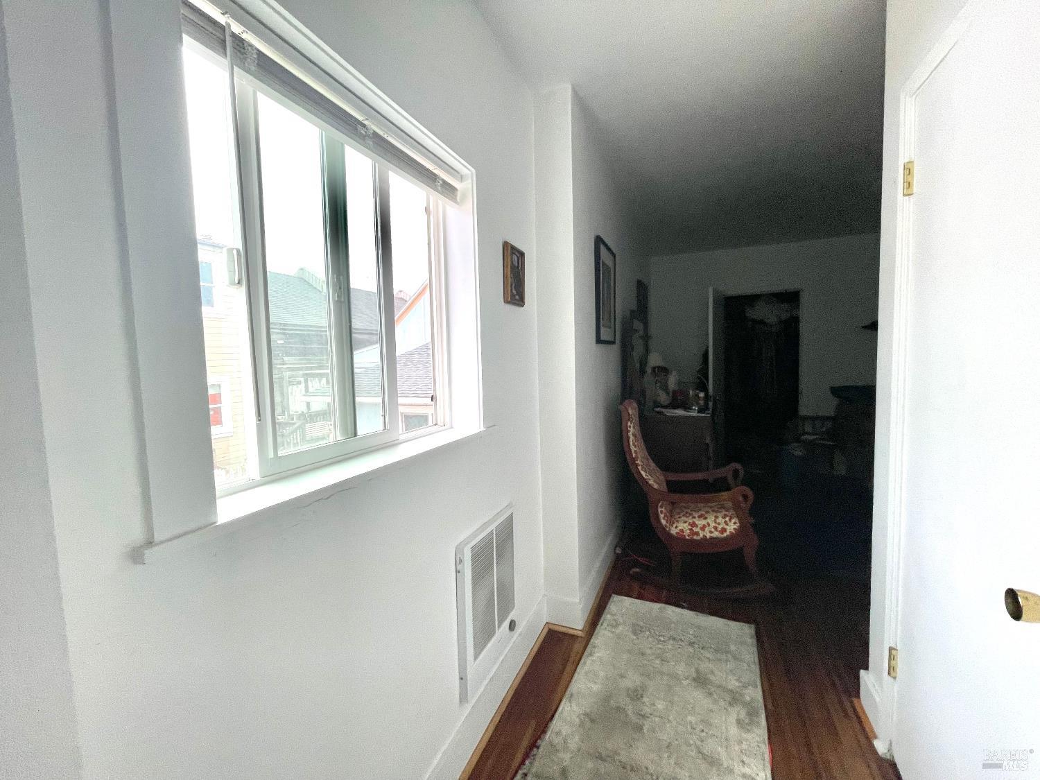 321 North Franklin Street Fort Bragg, CA 95437 - Photo 18 of 23 a view of hallway with wooden floor and a window