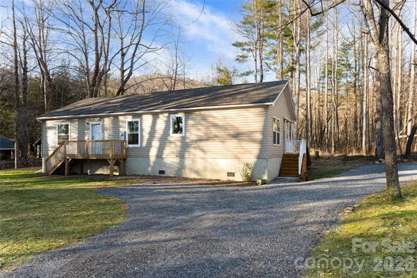 a view of a house with a backyard