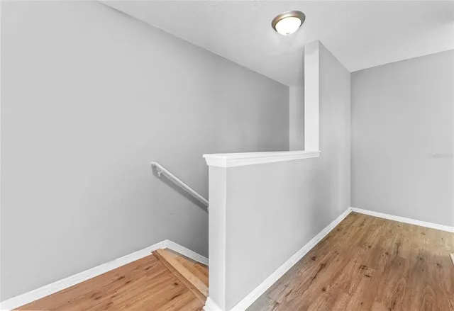 a view of hallway with wooden floor