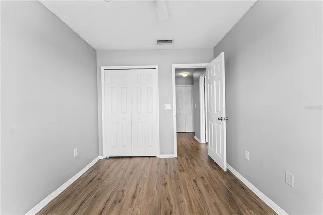 a view of hallway with wooden floor
