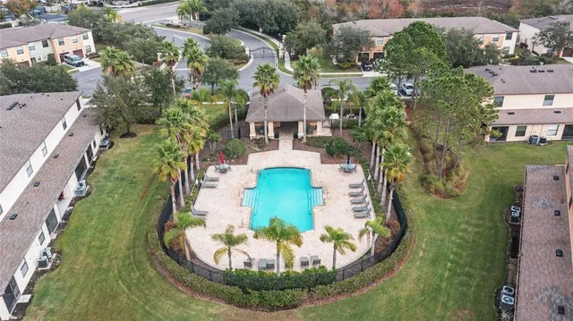 an aerial view of a house with a garden and trees