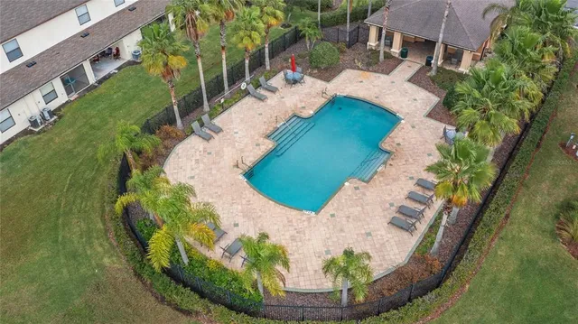a view of a swimming pool with a yard