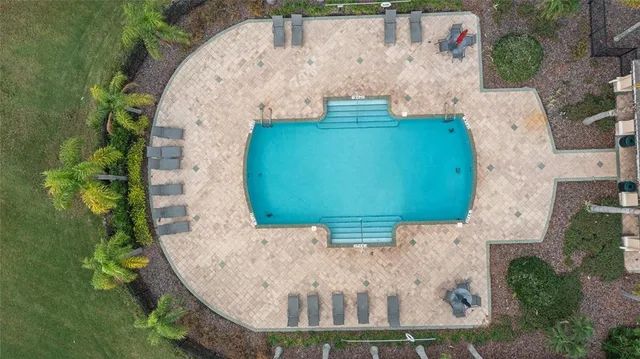 an aerial view of a house with a yard and large trees