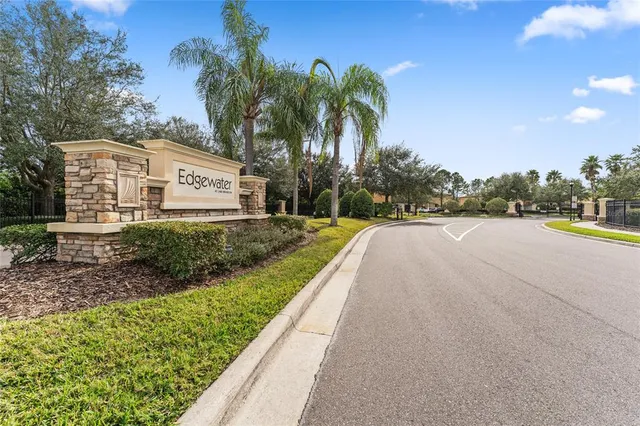 a view of a house with a yard and potted plants