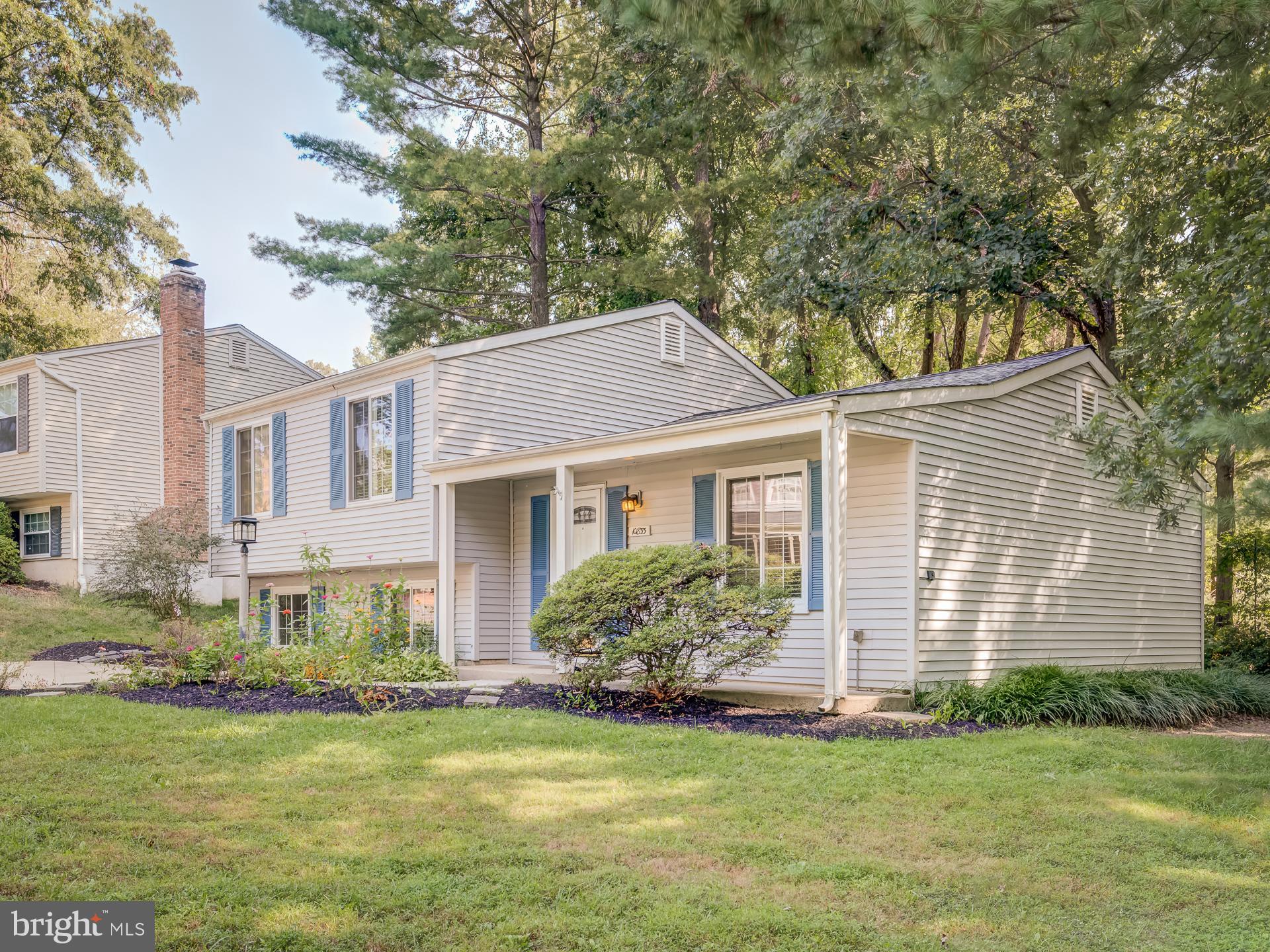 10833 Split Oak Lane Burke, VA 22015 - Photo 3 of 47 a front view of house with yard and green space