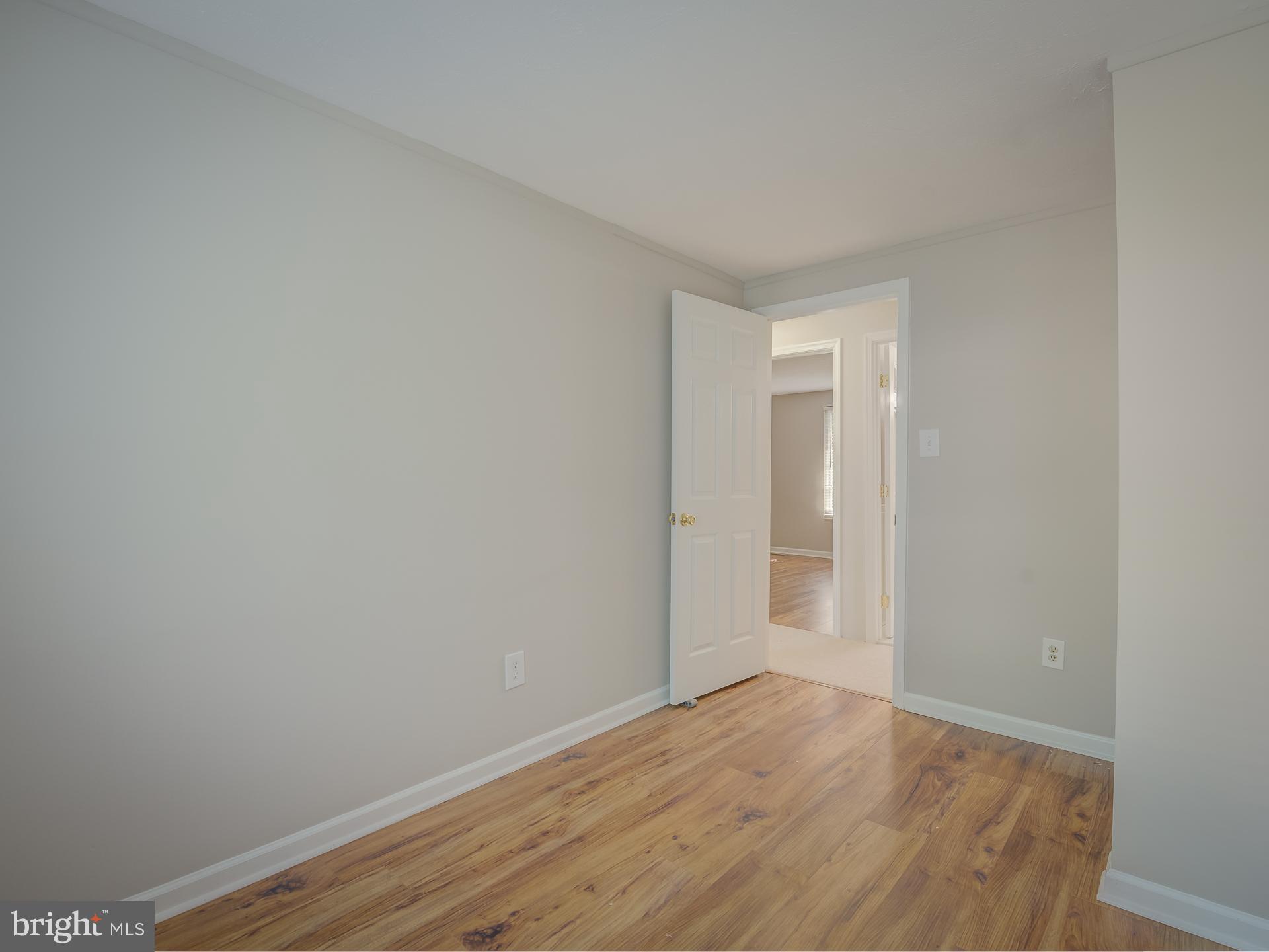 10833 Split Oak Lane Burke, VA 22015 - Photo 36 of 47 a view of an empty room with wooden floor