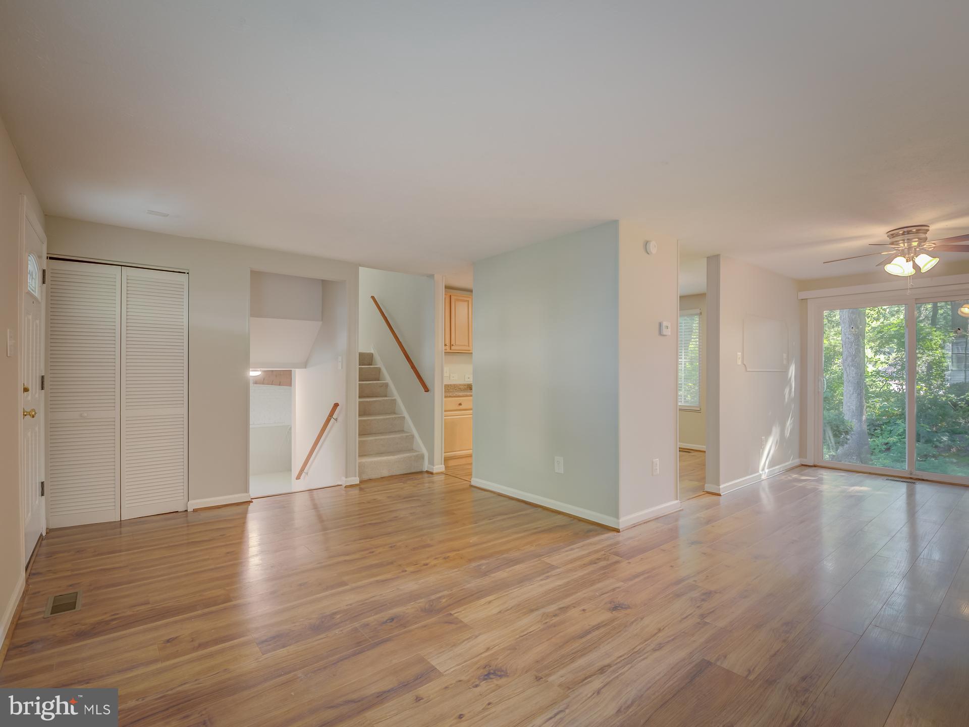 10833 Split Oak Lane Burke, VA 22015 - Photo 8 of 47 a view of empty room with wooden floor and windows