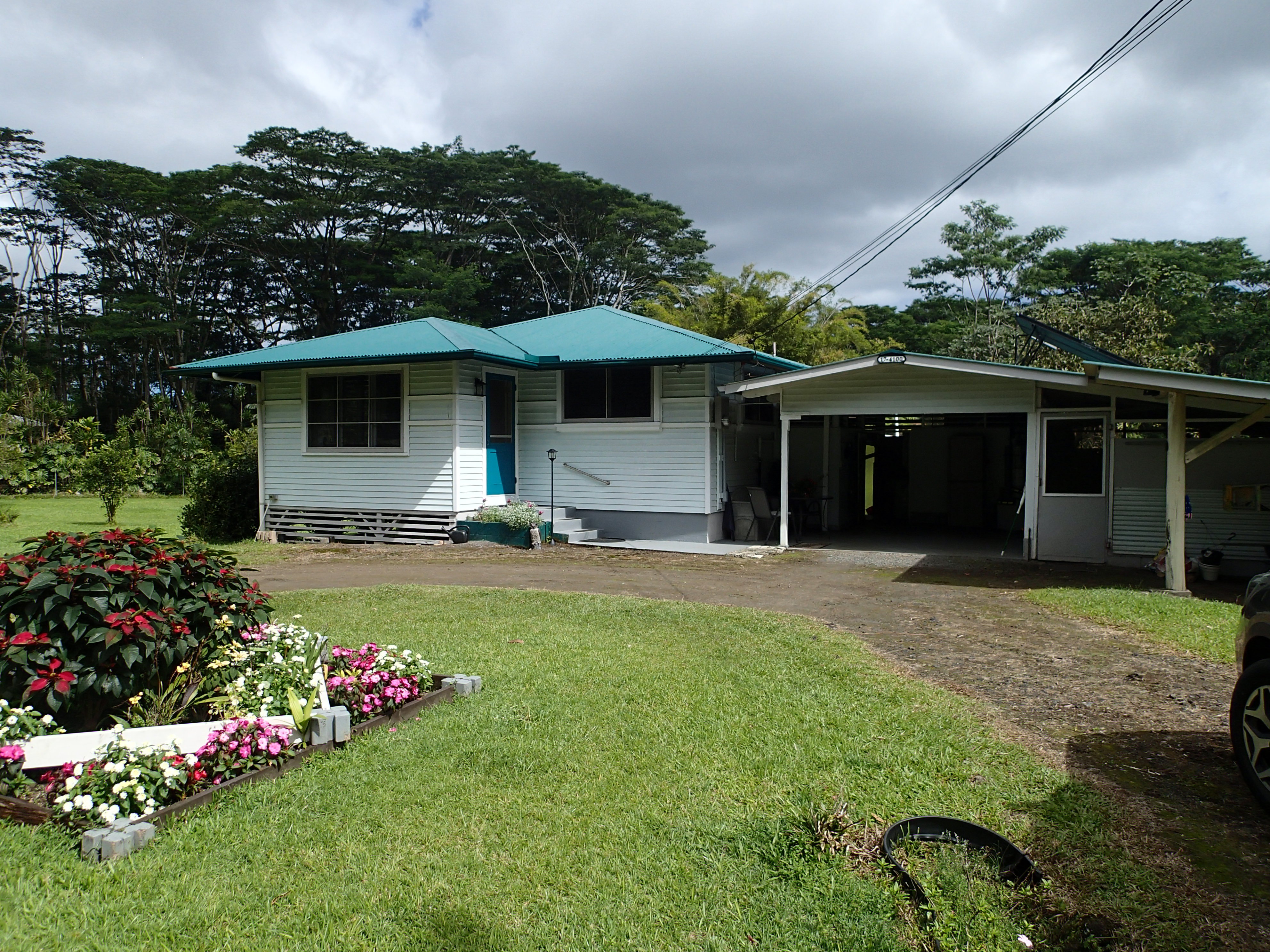 17-4100 Kukui Camp Road Kurtistown, HI 96760 - Photo 1 of 25 a front view of a house with garden