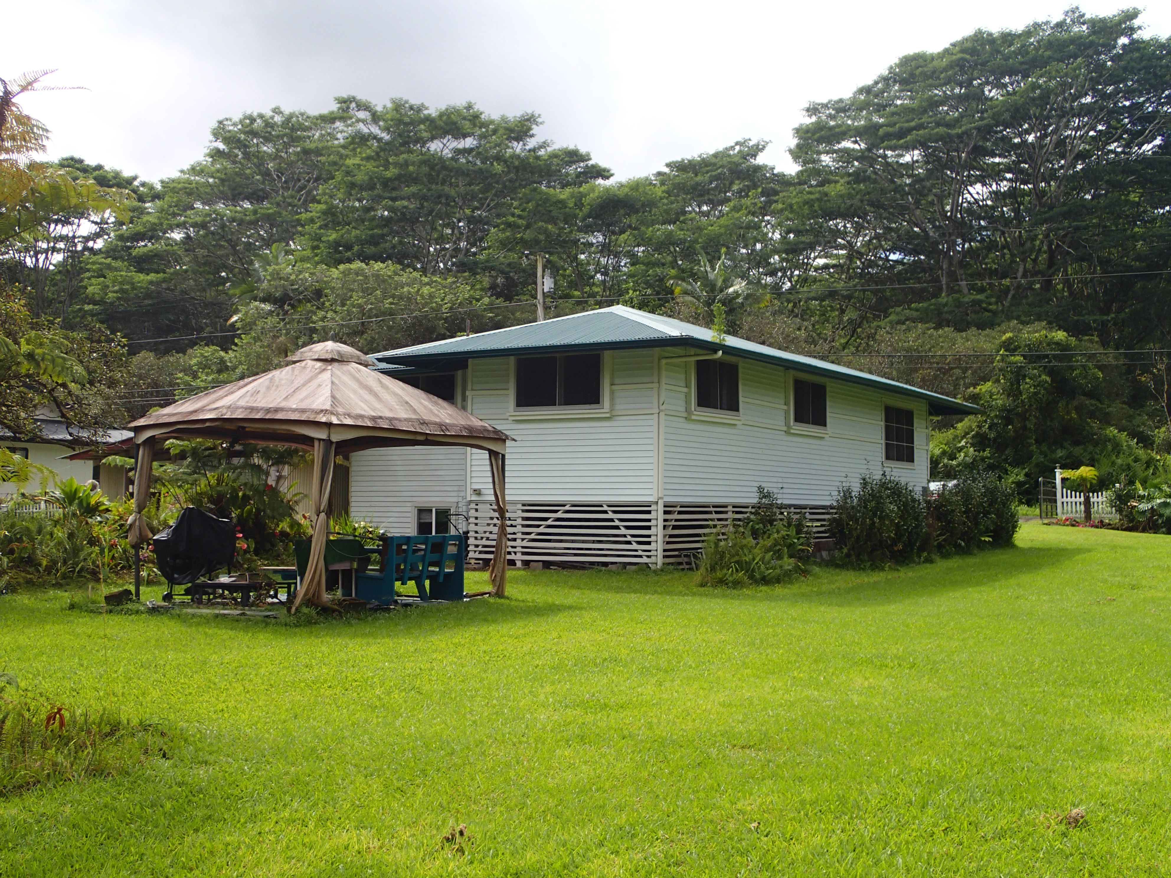 17-4100 Kukui Camp Road Kurtistown, HI 96760 - Photo 24 of 25 a backyard of a house with barbeque oven