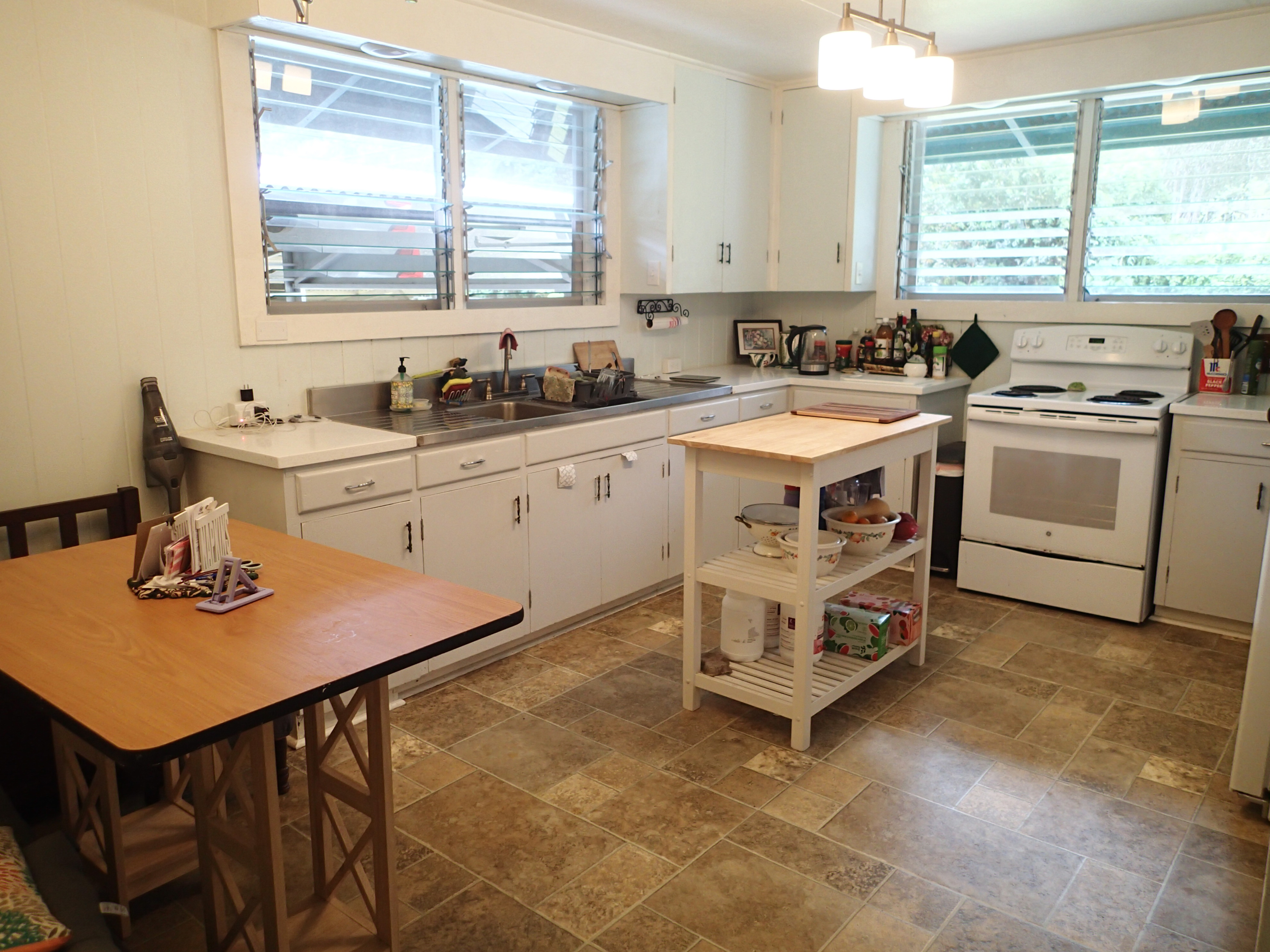 17-4100 Kukui Camp Road Kurtistown, HI 96760 - Photo 7 of 25 a kitchen with a stove window and cabinets