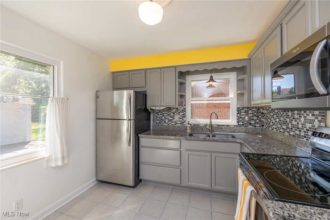 21475 Eaton Road Cleveland, OH 44126 - Photo 12 of 31 Kitchen featuring appliances with stainless steel finishes, a wealth of natural light, pendant lighting, and sink