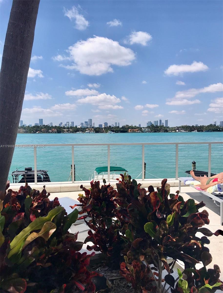 800 West Avenue, Unit 523 Miami Beach, FL 33139 - Photo 1 of 20 a view of a patio with lawn chairs and swimming pool