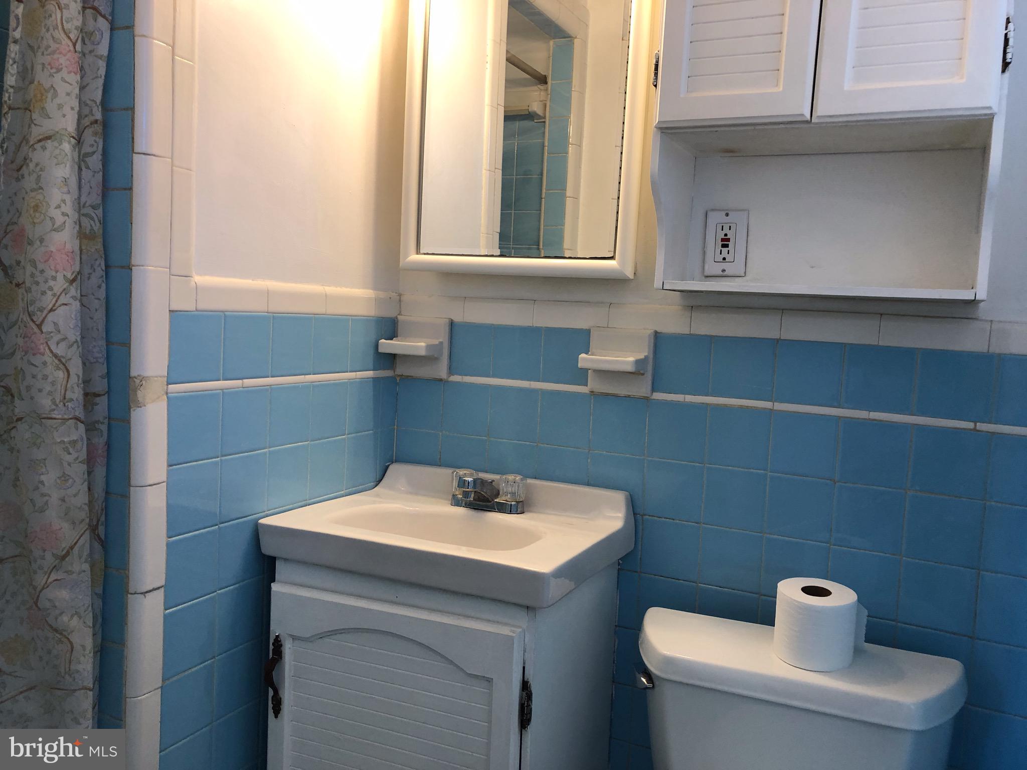 10005 Riggs Road Adelphi, MD 20783 - Photo 11 of 32 a bathroom with a sink a toilet and a mirror