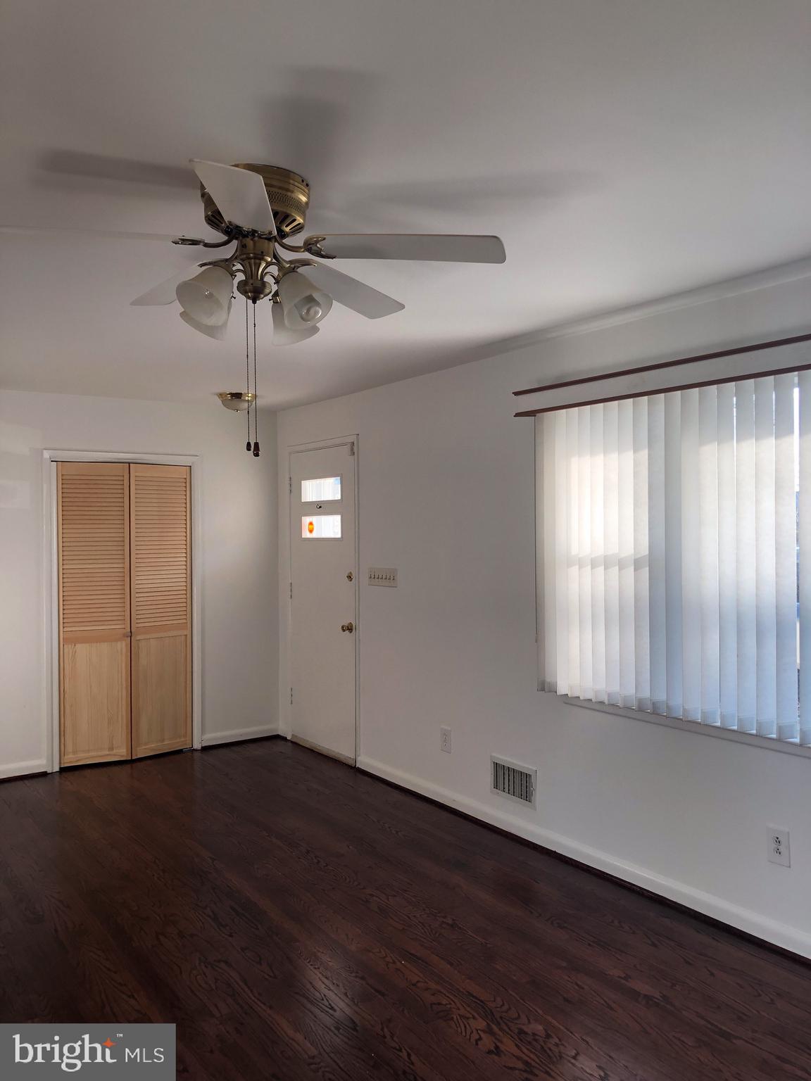 10005 Riggs Road Adelphi, MD 20783 - Photo 3 of 32 a view of an empty room with wooden floor and a window