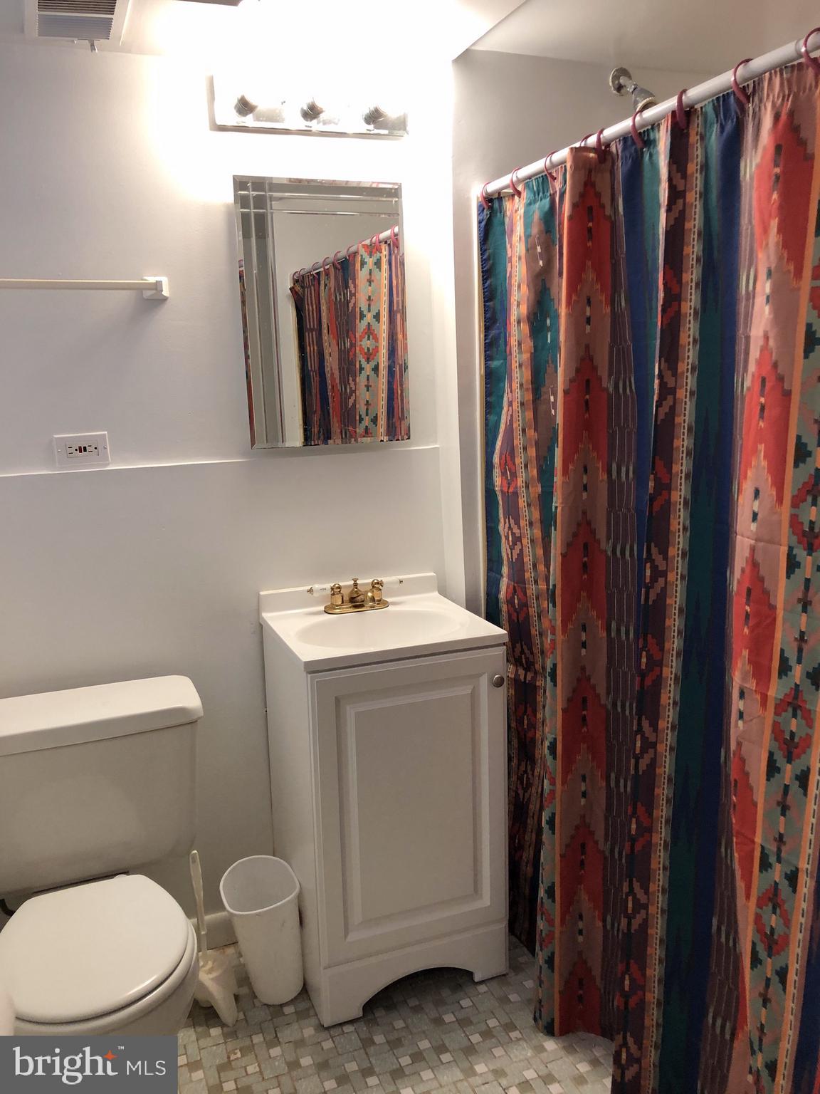 10005 Riggs Road Adelphi, MD 20783 - Photo 21 of 32 a bathroom with a toilet sink and mirror