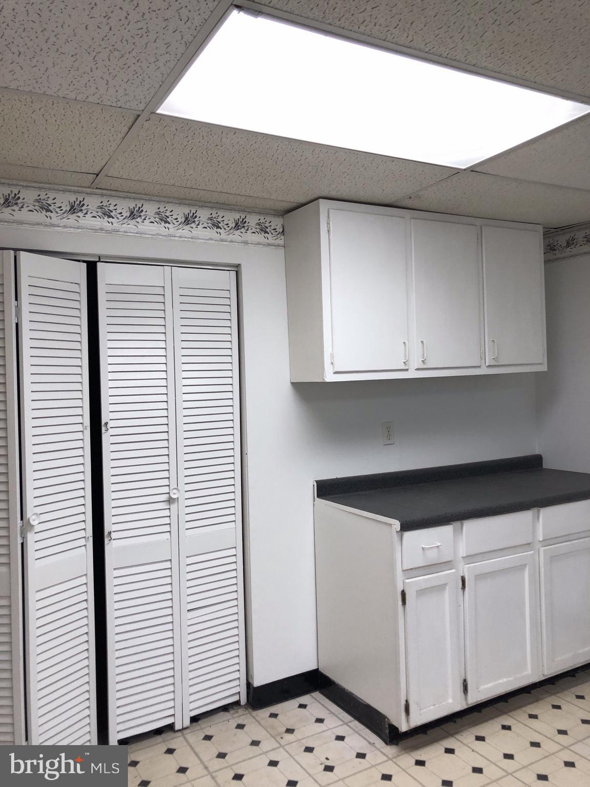 10005 Riggs Road Adelphi, MD 20783 - Photo 24 of 32 a kitchen with granite countertop white cabinets and white appliances