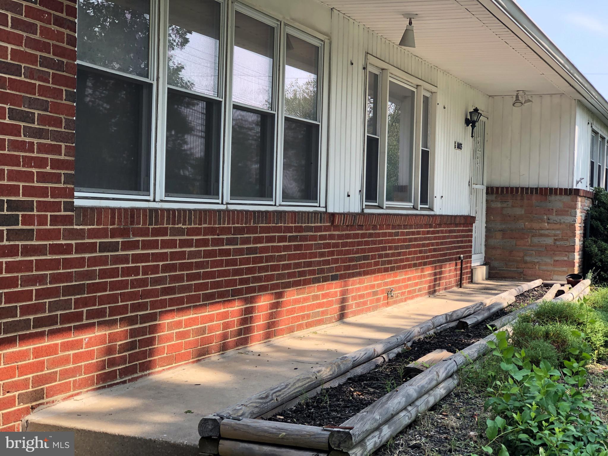 10005 Riggs Road Adelphi, MD 20783 - Photo 28 of 32 a view of a brick house with a large window