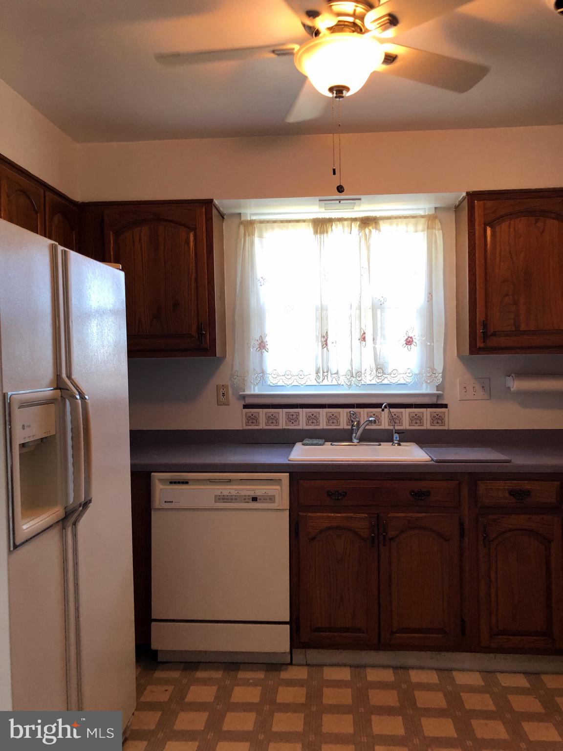 10005 Riggs Road Adelphi, MD 20783 - Photo 5 of 32 a kitchen with stainless steel appliances granite countertop a sink stove and refrigerator
