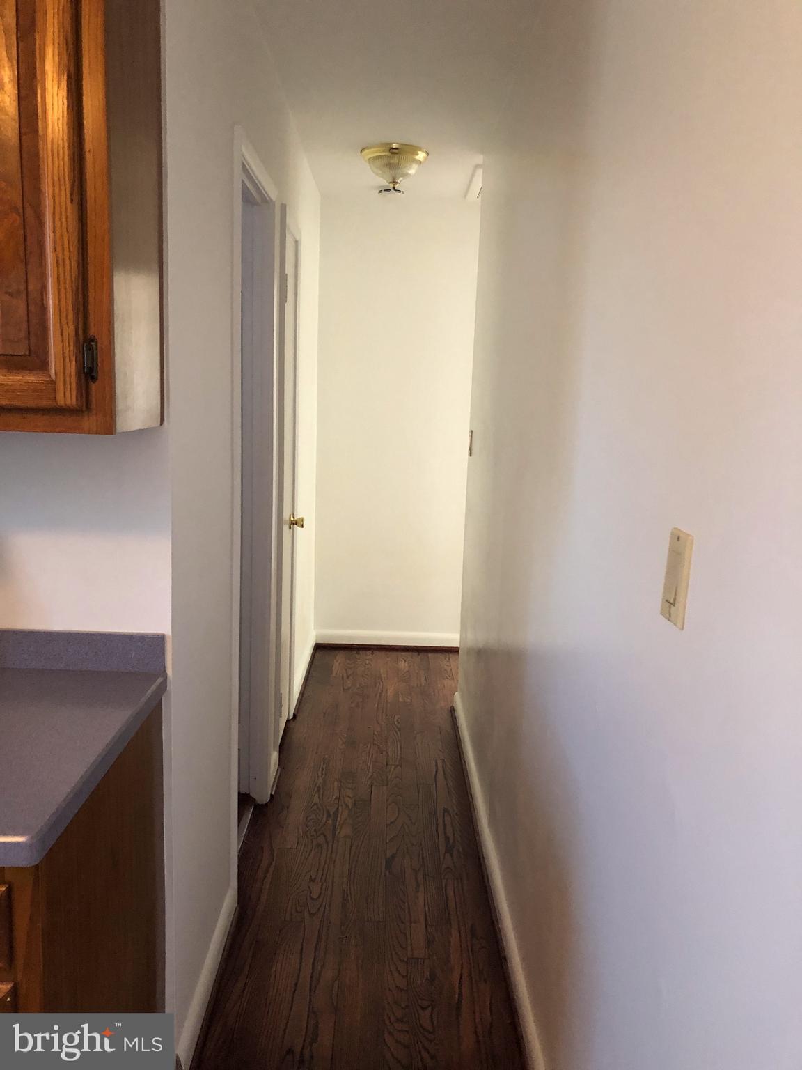 10005 Riggs Road Adelphi, MD 20783 - Photo 7 of 32 a view of a hallway with wooden floor