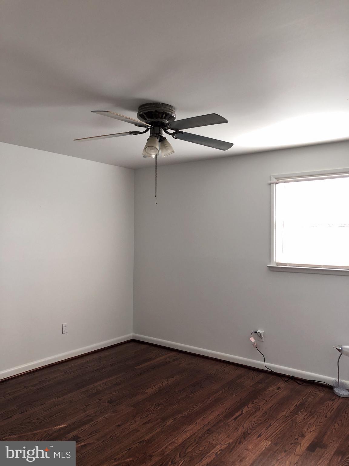 10005 Riggs Road Adelphi, MD 20783 - Photo 9 of 32 a view of an empty room with wooden floor and a window