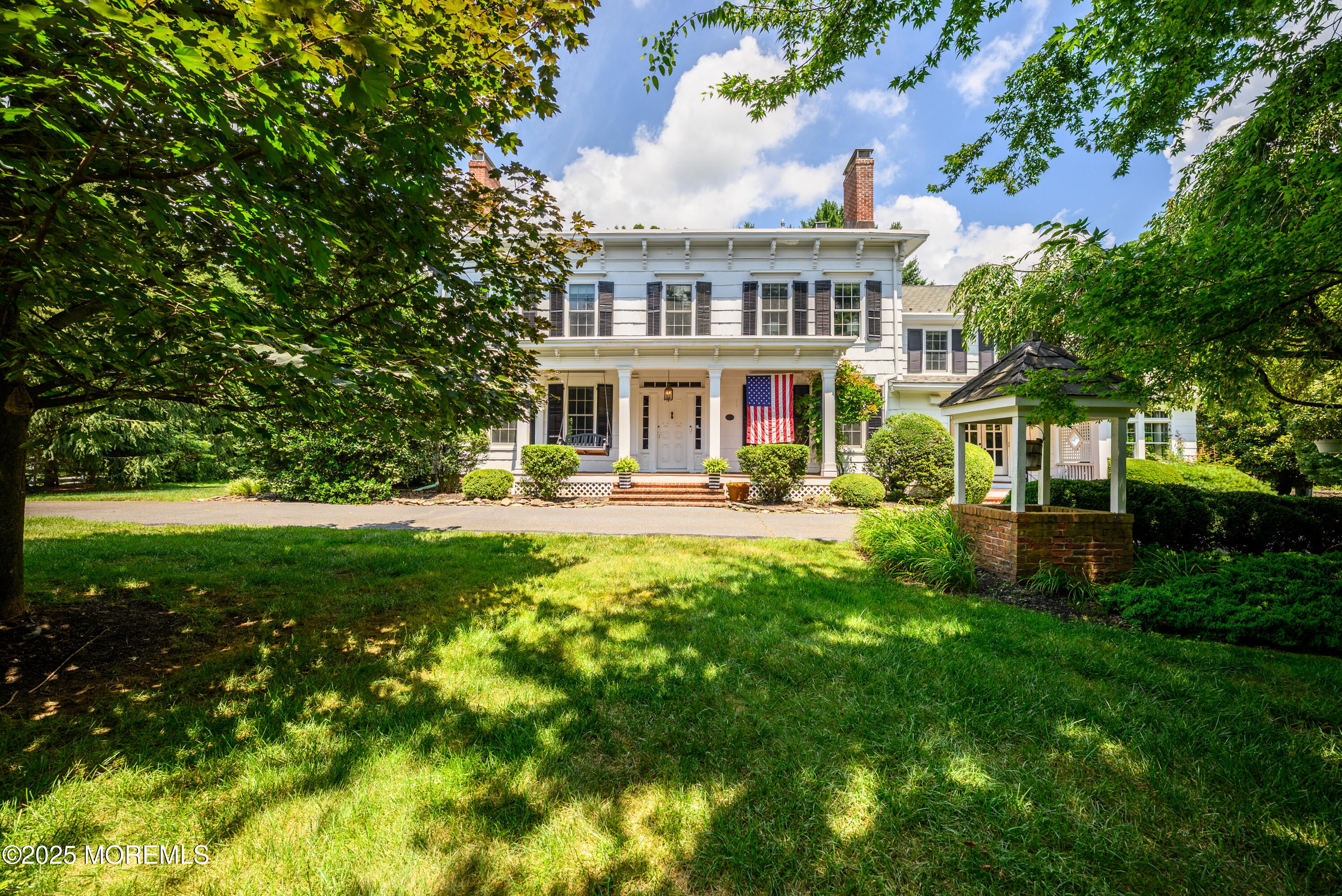 a view of a house with a yard balcony and sitting area