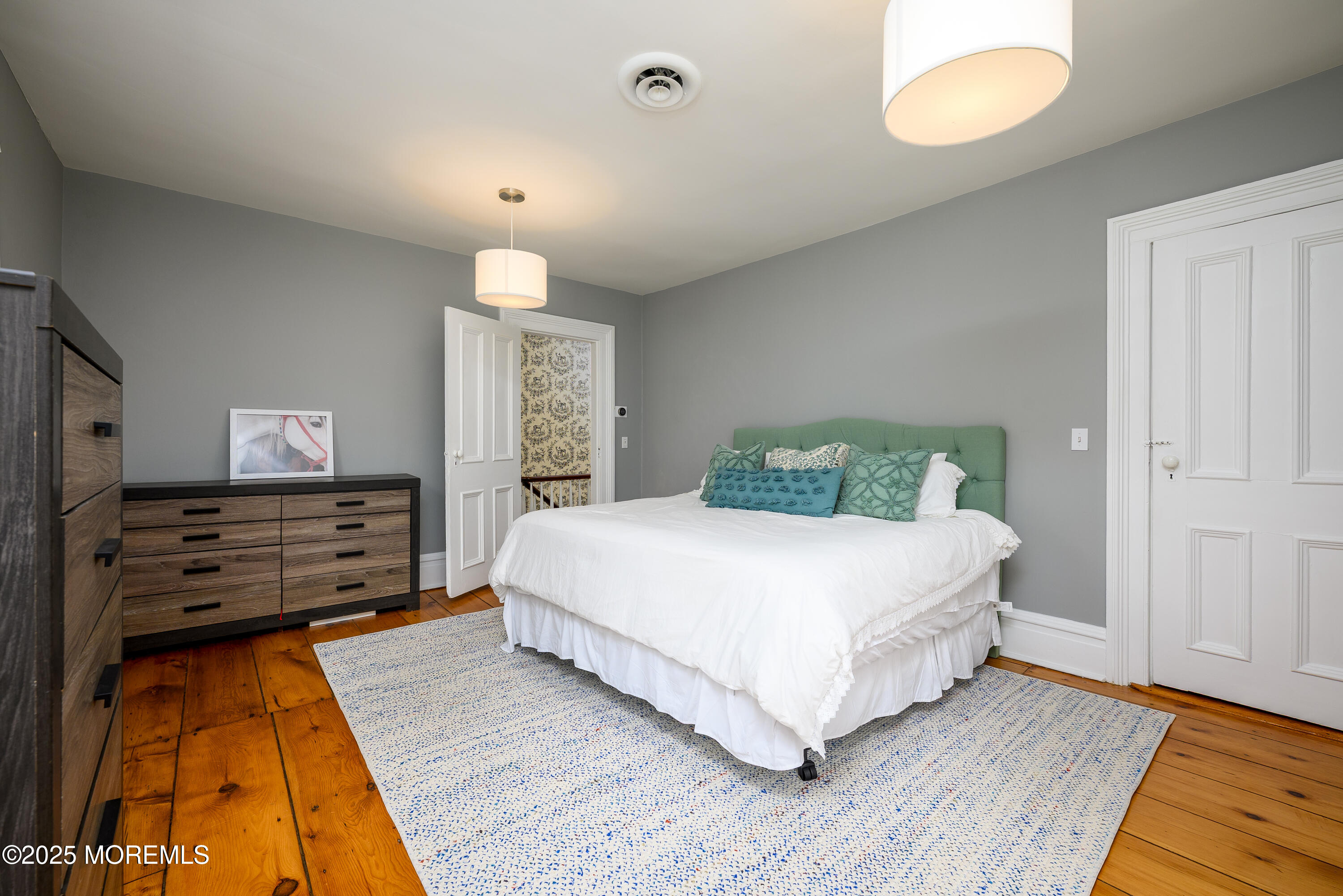 60 Conover Road Colts Neck, NJ 07722 - Photo 27 of 56 a bedroom with a bed and wooden floor