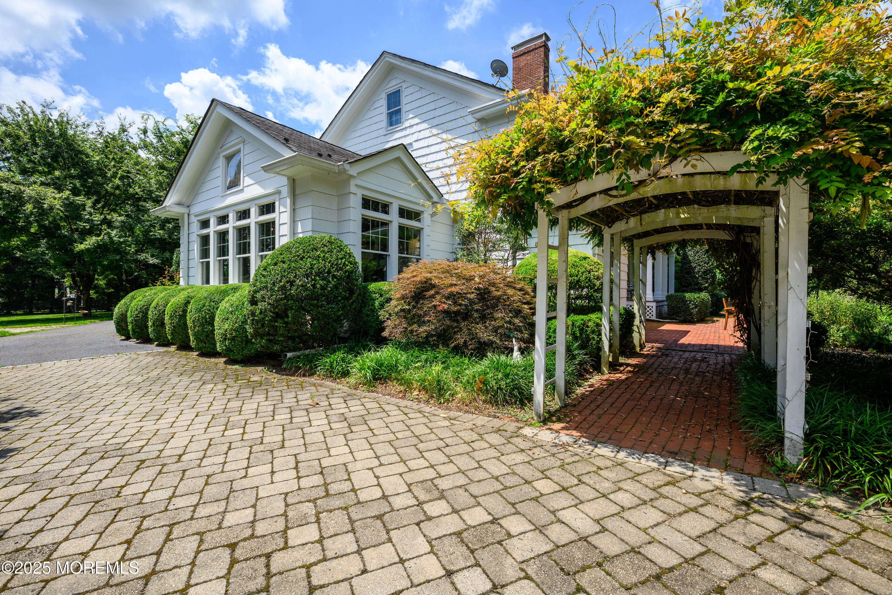 60 Conover Road Colts Neck, NJ 07722 - Photo 44 of 56 a view of a house with a small yard and a large tree