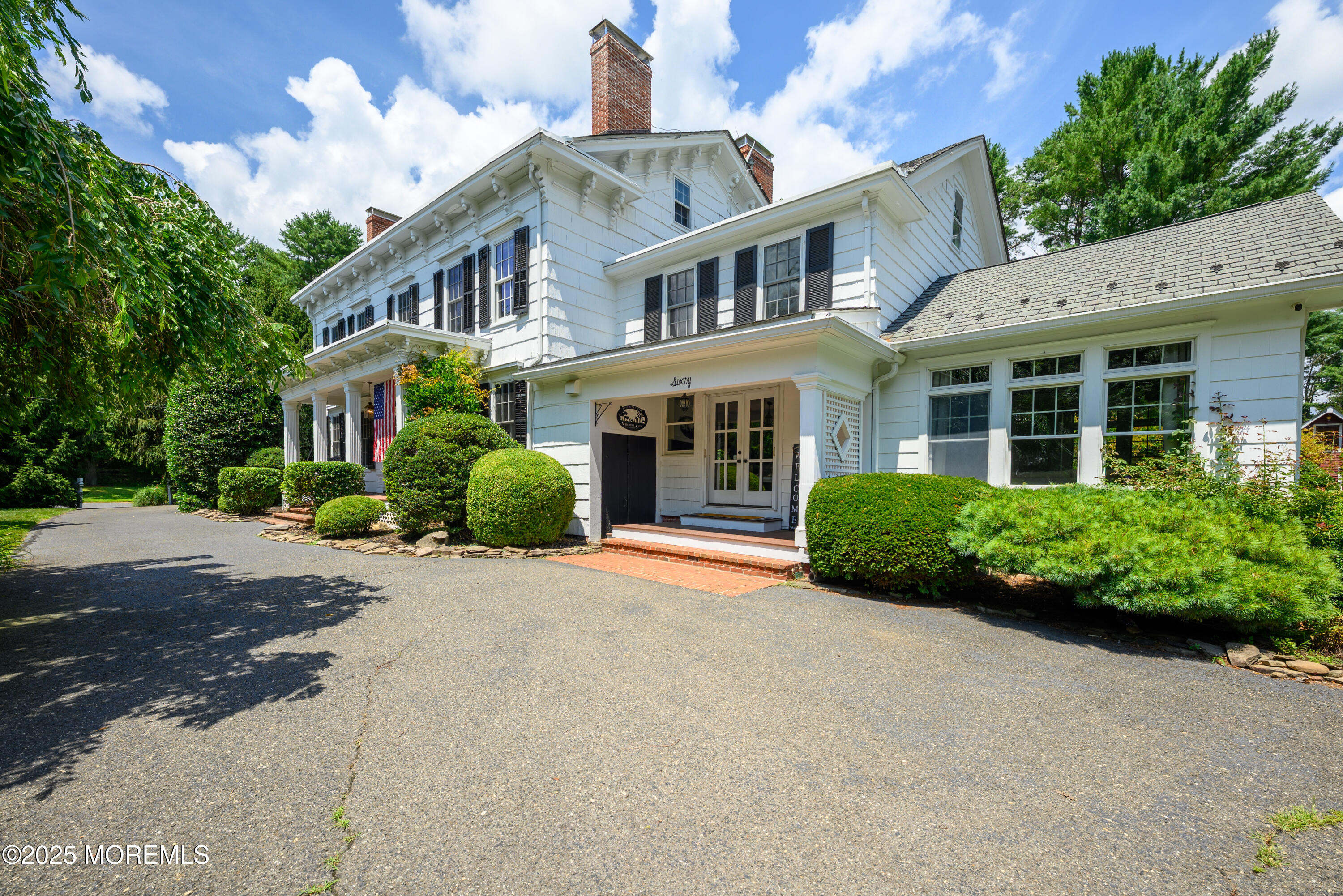 60 Conover Road Colts Neck, NJ 07722 - Photo 5 of 56 a front view of a house with plants and trees