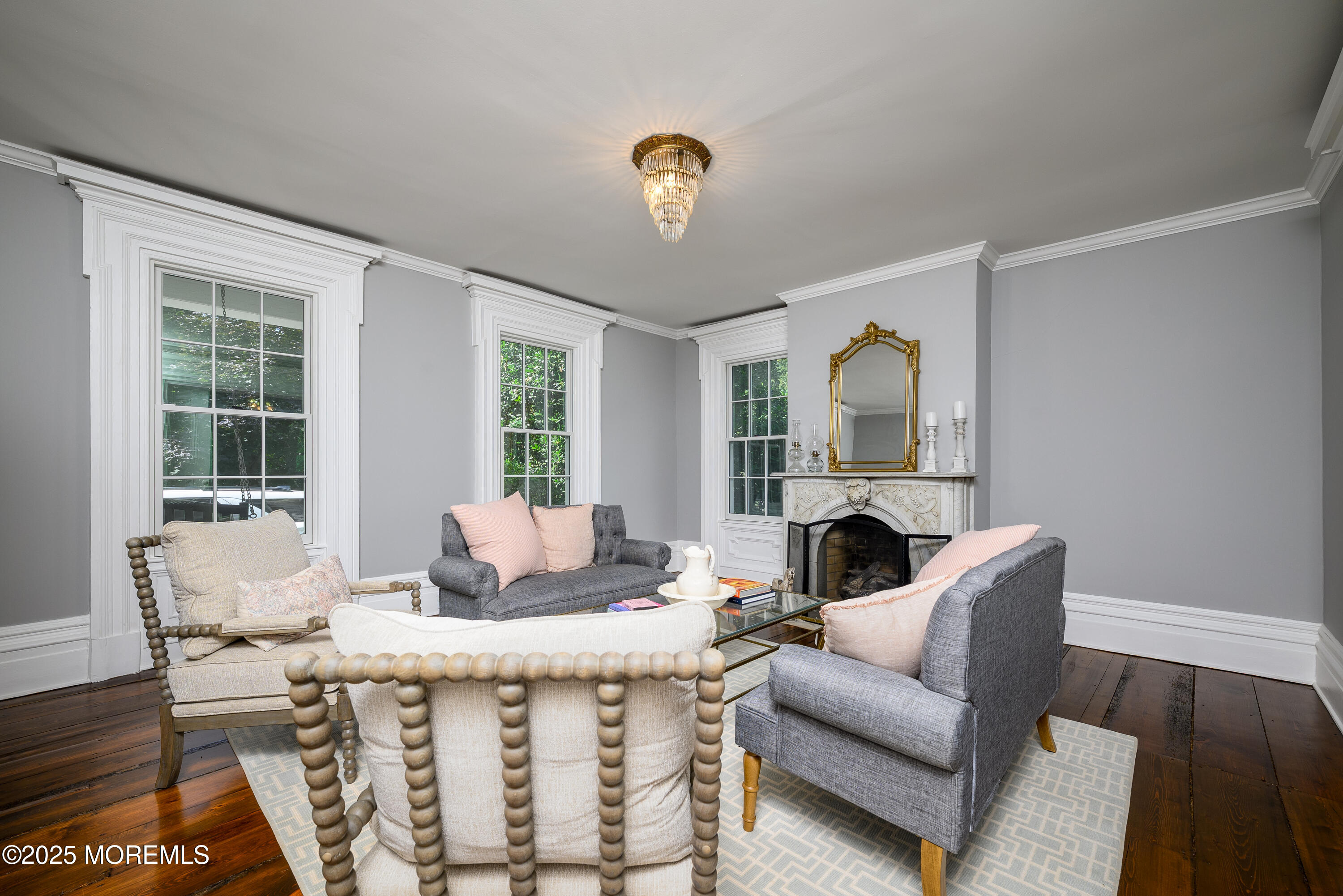 60 Conover Road Colts Neck, NJ 07722 - Photo 8 of 56 a living room with furniture a fireplace and a chandelier
